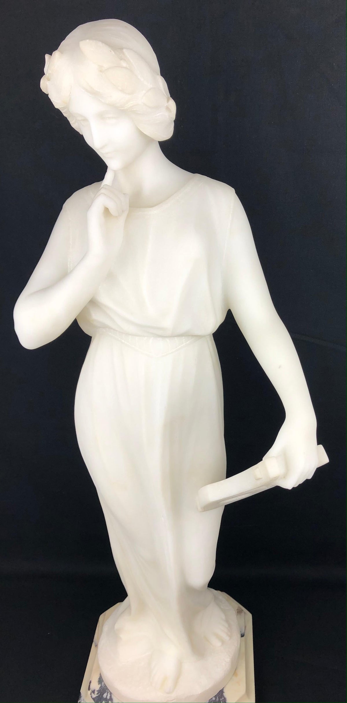 White Carrara marble figure of a woman in Art Nouveau dress on a tapered pedestal, signed Pugi, Florence