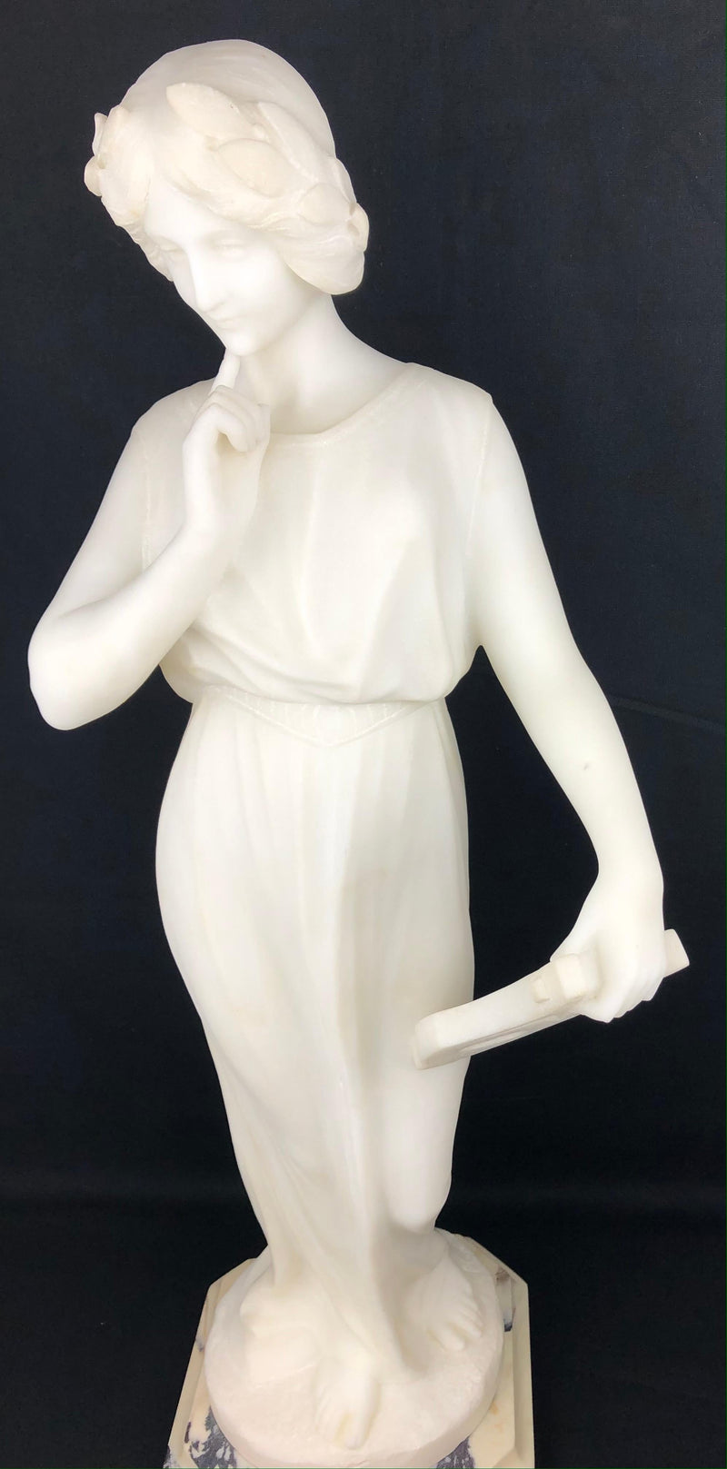 White Carrara marble figure of a woman in Art Nouveau dress on a tapered pedestal, signed Pugi, Florence