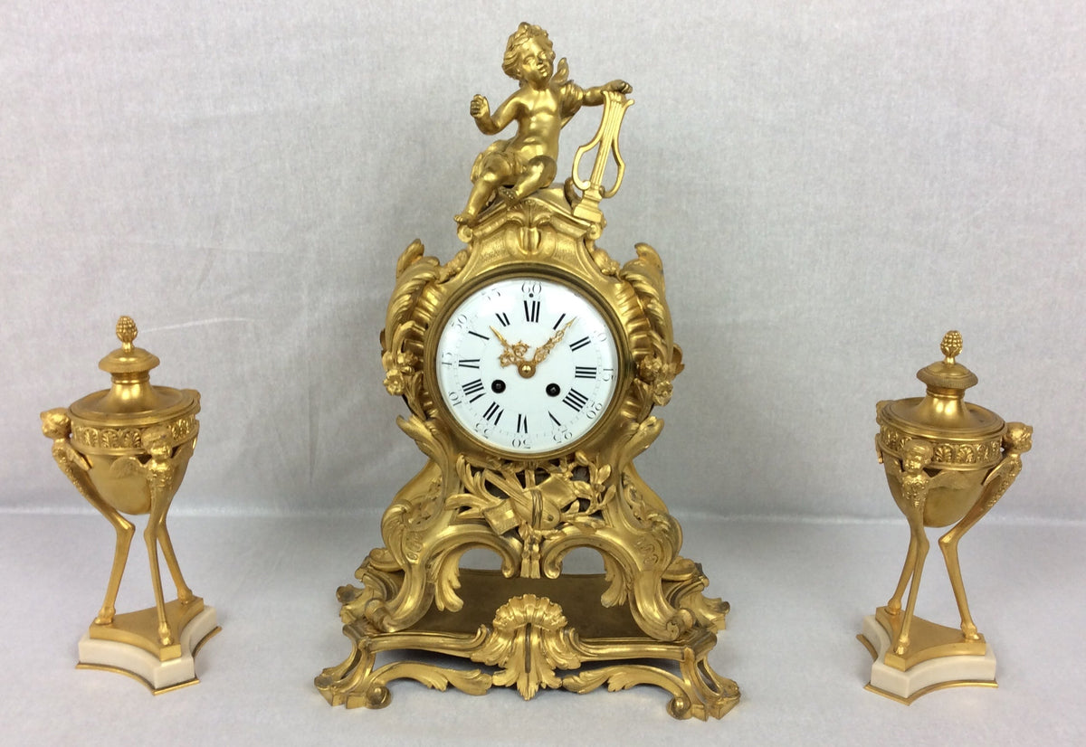 French Rococo ormolu mantel clock and garniture set, circa 1880, movement by Samuel Marti