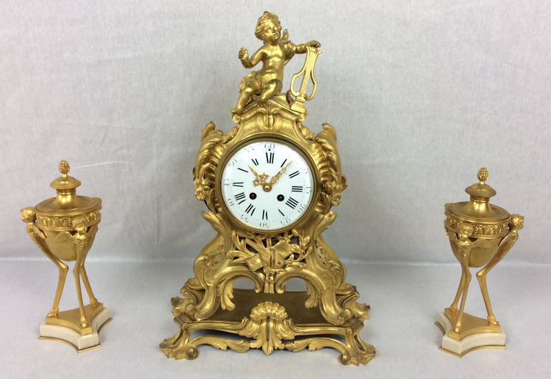 French Rococo ormolu mantel clock and garniture set, circa 1880, movement by Samuel Marti