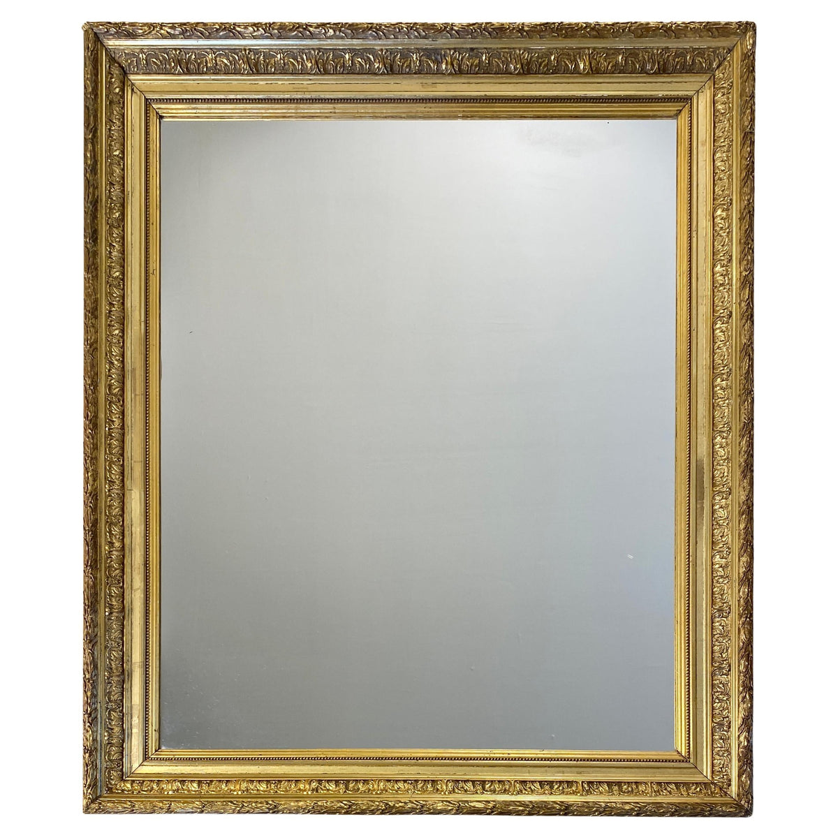 Large Louis XVI style giltwood mirror with carved frame detail
