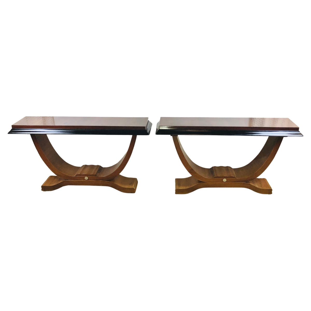Pair of French Art Deco console tables with nickeled trim, illustrating the period's geometric silhouette